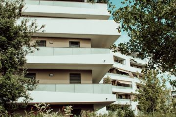 white concrete building near green trees during daytime