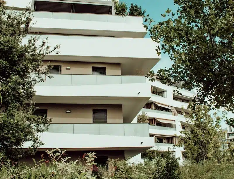 white concrete building near green trees during daytime